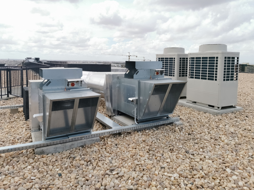 View of air ventilation ducts, extraction and insufflation, HVAC system, and exterior AC units on the building roof.